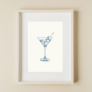 May include: A blue line drawing of a martini glass with olives on a toothpick. The glass is filled with a liquid and has a white background.