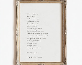 May include: A rectangular wall art print in a metallic gold ornate frame. The white paper features black cursive text reading: Love is patient, love is kind, it does not envy, it does not boast, it is not proud, it is not rude, it is not self-seeking, it is not easily angered, it keeps no record of wrongs. Love does not delight in evil but rejoices with the truth. It always protects, always trusts, always hopes, always perseveres. Love never fails. 1 Corinthians 13:4-8.