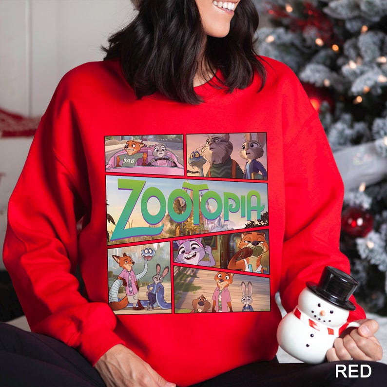 May include: A red sweatshirt featuring a comic strip design with characters and the title "Zootopia." The design includes various scenes from the animated movie. The word "RED" is printed in white at the bottom right.
