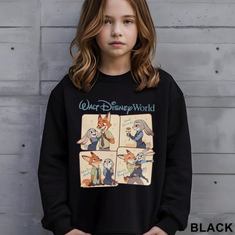May include: Black sweatshirt with a Walt Disney World logo and a four-panel graphic of Zootopia characters. The graphic includes the text "Sweet Surrender", "Adventure Awaits", and "Dancing Through Life".