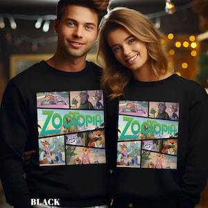 May include: Black sweatshirt featuring a colorful graphic from the animated movie "Zootopia." The design includes the movie title and various character panels. The word "BLACK" is printed at the bottom.