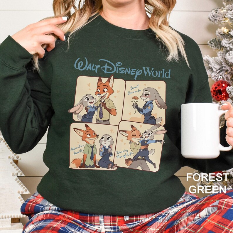 May include: Forest green sweatshirt with a Walt Disney World design. The graphic shows a fox and rabbit in four panels. The sweatshirt is worn with plaid pyjama bottoms. The text "Forest Green" is visible.