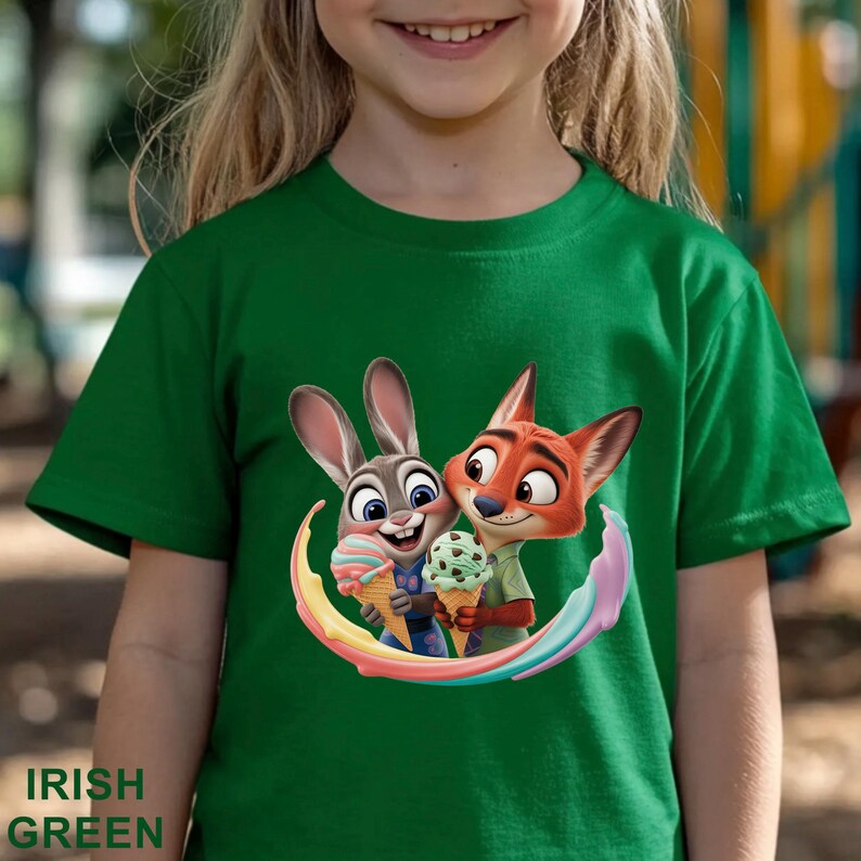 May include: A green t-shirt featuring a cartoon image of Judy Hopps and Nick Wilde from Zootopia holding ice cream cones. The shirt has the words "Irish Green" printed at the bottom. The characters are surrounded by a rainbow arc.