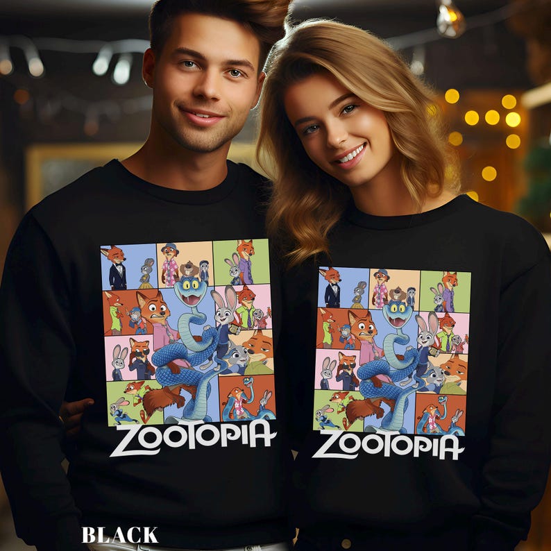 May include: Black sweatshirts featuring a colorful Zootopia cartoon design. The design includes various characters from the movie, with the word "Zootopia" in white script at the bottom. The sweatshirts are long-sleeved.
