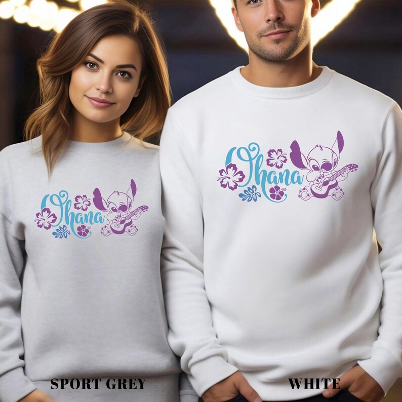 May include: Sport grey and white sweatshirts featuring a purple and blue graphic of a cartoon character playing a guitar, with the word "Ohana" above. The sweatshirts are shown with the text "SPORT GREY" and "WHITE" below.