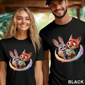 May include: Black t-shirts featuring a cartoon image of a bunny and fox holding ice cream cones, surrounded by a rainbow arc. The word "BLACK" is printed at the bottom of the image.