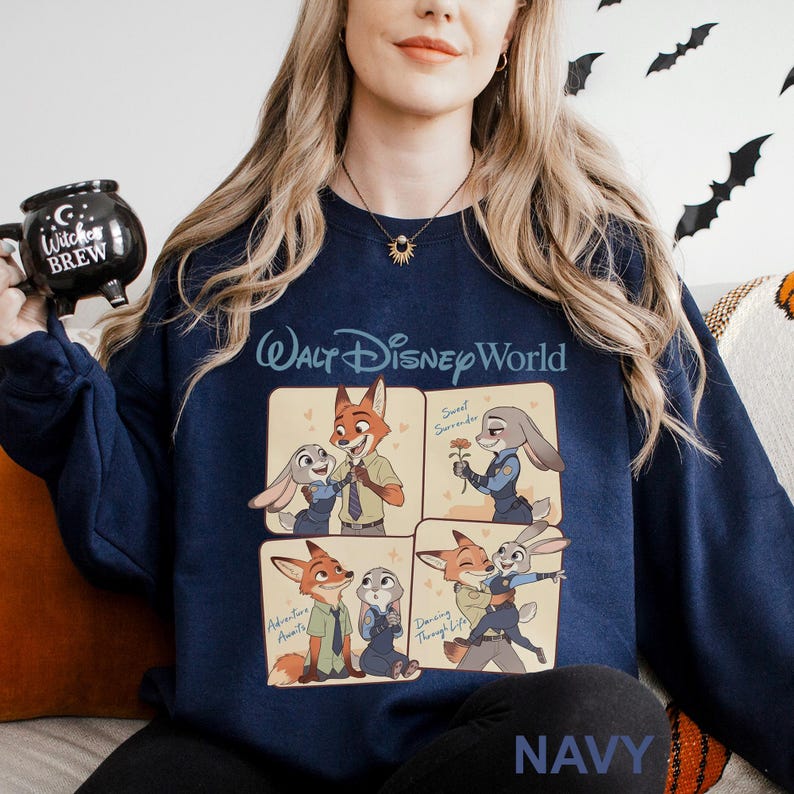 May include: Navy blue sweatshirt with a four-panel illustration of Zootopia characters. The words "Walt Disney World" are printed in white across the chest. The word "NAVY" is printed in white at the bottom of the sweatshirt.