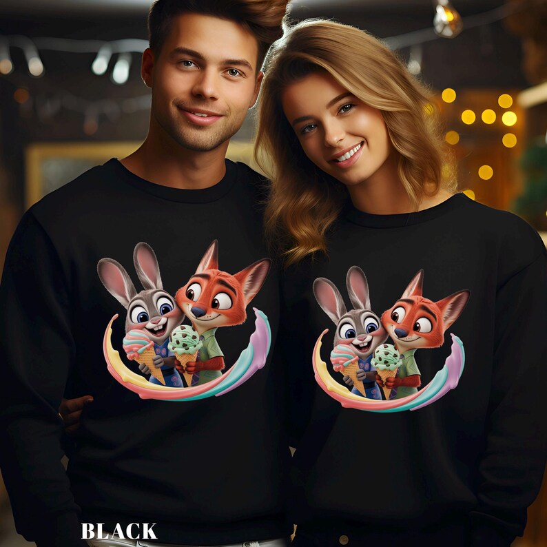 May include: Black sweatshirts featuring a cartoon image of a bunny and fox holding ice cream cones, surrounded by a rainbow arc. The word "BLACK" is printed at the bottom of the sweatshirt.