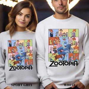 May include: Sport grey and white sweatshirts featuring a colorful graphic from the animated film Zootopia. The design includes various characters in a grid pattern, with the film's title in bold black letters at the bottom. The sweatshirts are displayed on a woman and a man.