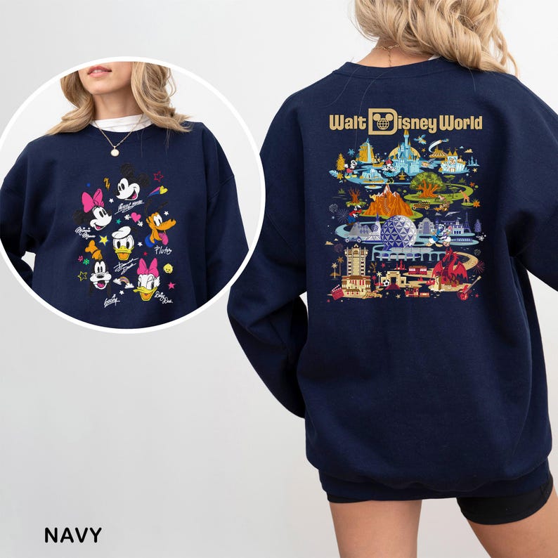 May include: Navy blue sweatshirt featuring a colorful graphic of Disney characters on the front and a detailed illustration of Walt Disney World on the back. The sweatshirt includes the text "Walt Disney World".