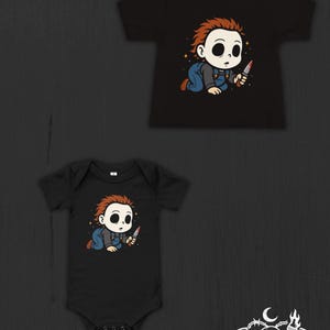 May include: A black short-sleeved t-shirt and a black short-sleeved bodysuit, both featuring a graphic of a cartoon character with brown hair, a white mask, and blue overalls, crawling while holding a small knife. The logo Nocturnal Nursery Co is visible.