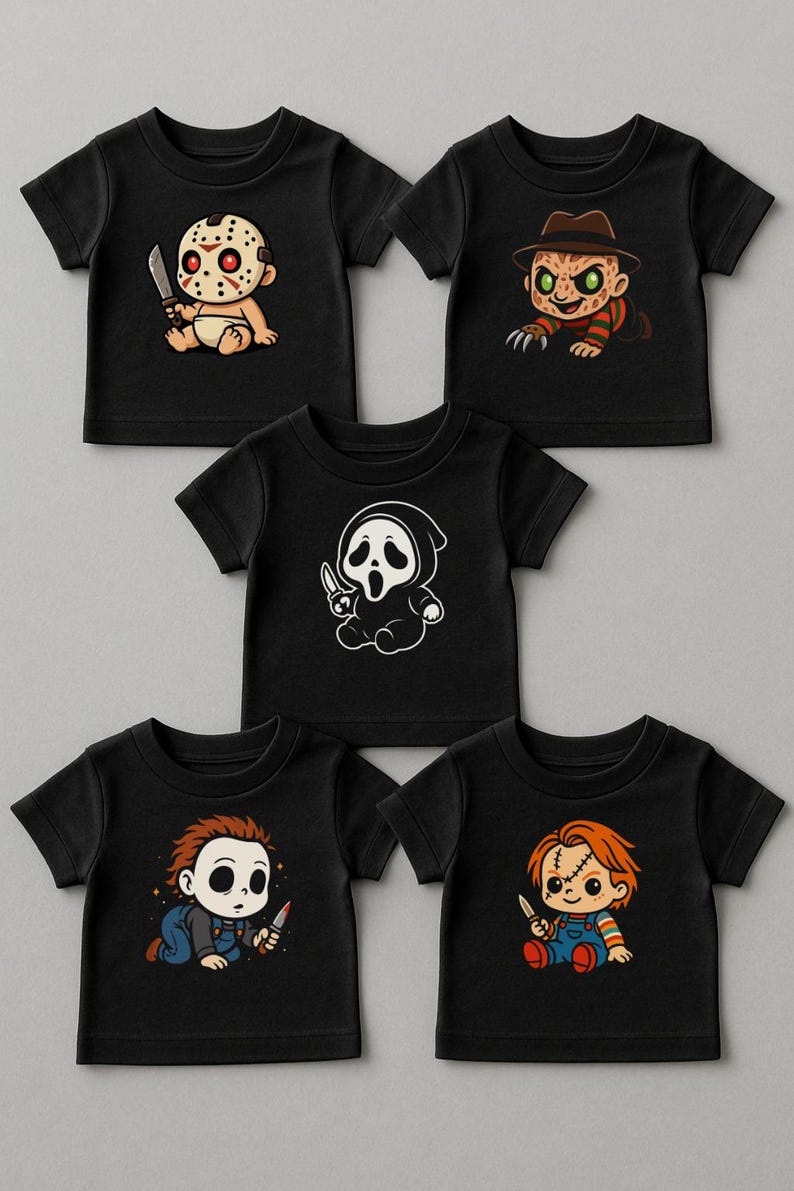 May include: Five black short-sleeve t-shirts featuring cartoon horror character graphics. The designs include a hockey-masked figure with a knife, a clawed figure in a fedora, a hooded ghost figure, a masked figure in overalls, and a doll in overalls.