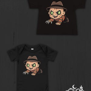 May include: A black short-sleeved t-shirt and a black short-sleeved bodysuit, both featuring a graphic of a cartoon character wearing a brown fedora, a red and green striped sweater, and a glove with sharp blades, with the text Nocturnal Nursery Co.