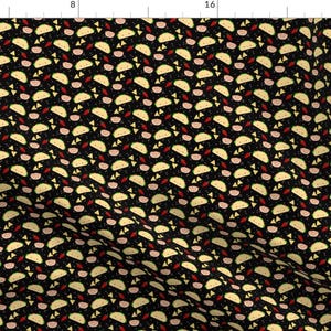 May include: A black fabric with a repeating pattern of tacos, salsa, and other food items. The tacos are yellow and green, the salsa is red, and the other items are pink and yellow. The pattern is evenly spaced.