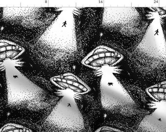 May include: Black and white repeating pattern featuring stylised UFOs with beams of light shining down on a dark starry background. The UFOs are drawn in a stippled style.