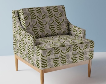 May include: A beige armchair with wooden legs and a green floral pattern upholstery.