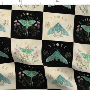 May include: A black and cream checkered fabric with a repeating pattern of green and blue moths, crescent moons, and floral designs.
