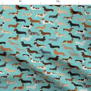 May include: A seamless pattern featuring a variety of dachshund dogs in different colors and poses on a turquoise background. The dogs are all facing forward and have their tails wagging.
