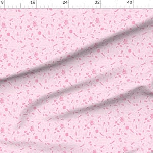 May include: A pink fabric with a repeating pattern of pink abstract shapes. The fabric has a subtle texture.
