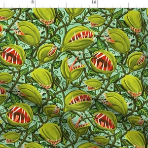 May include: A seamless pattern featuring a repeating design of green, toothy, carnivorous plants with red mouths on a light blue background.