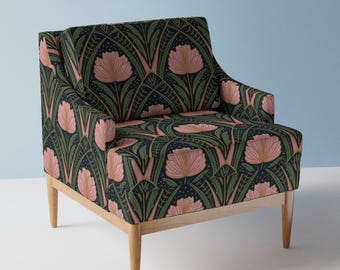 May include: An upholstered armchair with a floral pattern. The chair features a dark navy blue background with pink flowers and green leaves. The wooden legs are a light natural color.