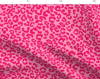 May include: Pink fabric with a leopard print pattern. The print is a solid pink color on a lighter pink background.