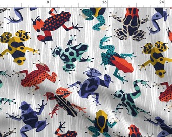 May include: A white background with a repeating pattern of colorful frogs. The frogs are in various poses and have different patterns, including red, blue, yellow, green, and black.