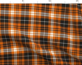 May include: Orange, black, and white plaid fabric with a subtle grey stripe. The fabric is folded in the center.