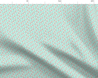 May include: A teal fabric with a repeating pattern of small pink flowers.