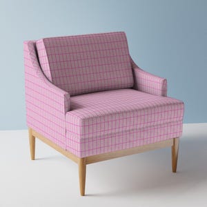May include: A pink armchair with a grid pattern in a darker pink. The chair has a light wood frame and legs. The chair has a high back and armrests.