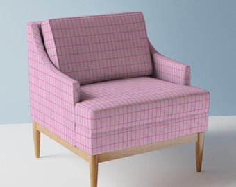 May include: A pink armchair with a grid pattern in a darker pink. The chair has a light wood frame and legs. The chair has a high back and armrests.