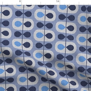 May include: A repeating pattern of blue and white teardrop shapes on a light blue background. The pattern is reminiscent of a retro design.