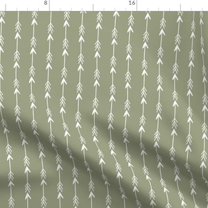 May include: A green fabric with a repeating pattern of white arrows pointing upwards. The arrows are arranged in vertical lines.