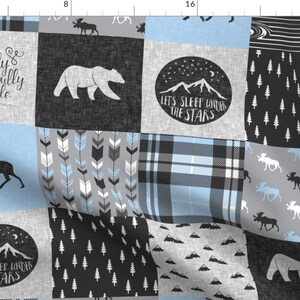 May include: A patchwork fabric design featuring a variety of patterns, including plaid, arrows, trees, and mountains. The fabric is in shades of blue, grey, and black. The text "I am fearfully and wonderfully made" and "Let's sleep under the stars" is included in the design.