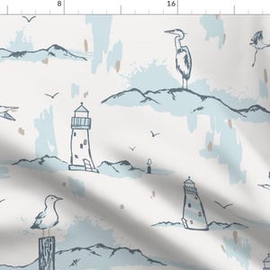 May include: A white fabric with a repeating pattern of lighthouses, birds, and brushstrokes in shades of blue and brown.