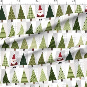 May include: A fabric featuring a repeating pattern of green Christmas trees and Santa Claus figures on a white and grey background. The trees have various patterns and shades of green. Santa Claus wears a red hat and suit.