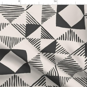 May include: Black and white geometric pattern with a cream background. The pattern features squares, triangles, and lines.