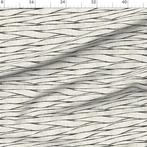 May include: A white fabric with a black wavy line pattern. The lines are thin and create a subtle, textured look.