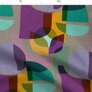 May include: Abstract geometric pattern fabric with overlapping circles and squares in shades of purple, teal, green, yellow, and brown on a light grey background.