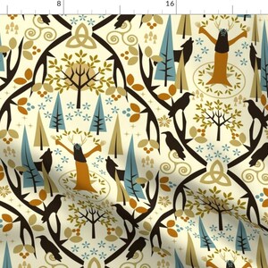 May include: A cream-colored fabric with a repeating pattern of stylized trees, wolves, ravens, and a woman with antlers. The pattern is in shades of brown, gold, blue, and white.