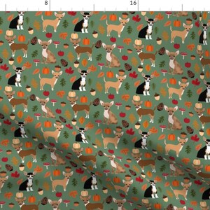 May include: A green fabric with a repeating pattern of brown and white chihuahua dogs, pumpkins, acorns, and fall leaves.