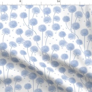 May include: A seamless pattern featuring a repeating design of light blue dandelion flowers on a white background.