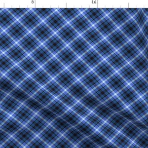 May include: Blue and white plaid fabric with a diagonal pattern. The fabric is woven with thin stripes of blue, white, and black.