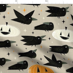 May include: A beige fabric with a repeating pattern of black crows and white and orange jack-o'-lanterns. The crows are stylized and have a geometric design. The jack-o'-lanterns are simple and have a smiling face.