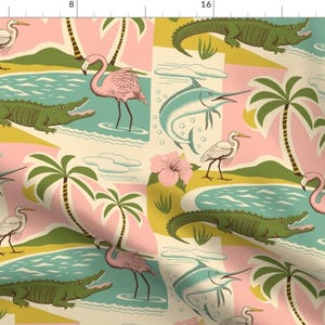 May include: A colorful tropical pattern featuring pink flamingos, white herons, green alligators, blue marlin, palm trees, and pink hibiscus flowers on a cream background.