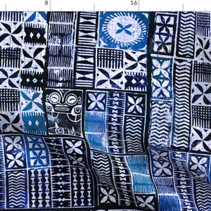 May include: A blue and white patterned fabric with a geometric design. The fabric features a repeating pattern of squares and rectangles with different designs, including a tiki head.