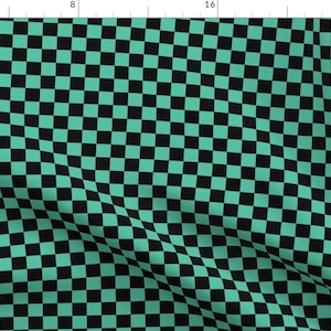 May include: A checkered pattern fabric with alternating black and teal green squares.