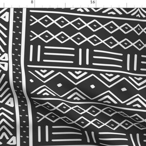 May include: Black and white geometric pattern fabric with a repeating design of triangles, diamonds, and lines. The fabric is folded in the center.