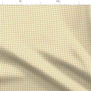 May include: Cream-coloured fabric featuring a repeating pattern of small, golden-yellow triangles. The triangles are evenly spaced, creating a textured appearance. The fabric is suitable for sewing or crafting.