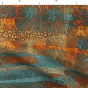 May include: Abstract fabric with a textured design in shades of teal, orange, and brown. The pattern features geometric shapes and lines, creating a layered effect. The fabric appears to have a watercolor or painted aesthetic.